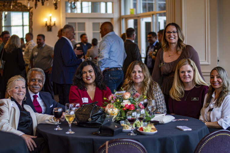 Representatives from Placer Title pose for a photo at their table with Policy Makers