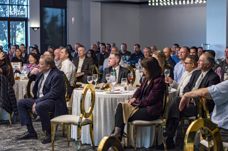 Attendees listen to presentation.